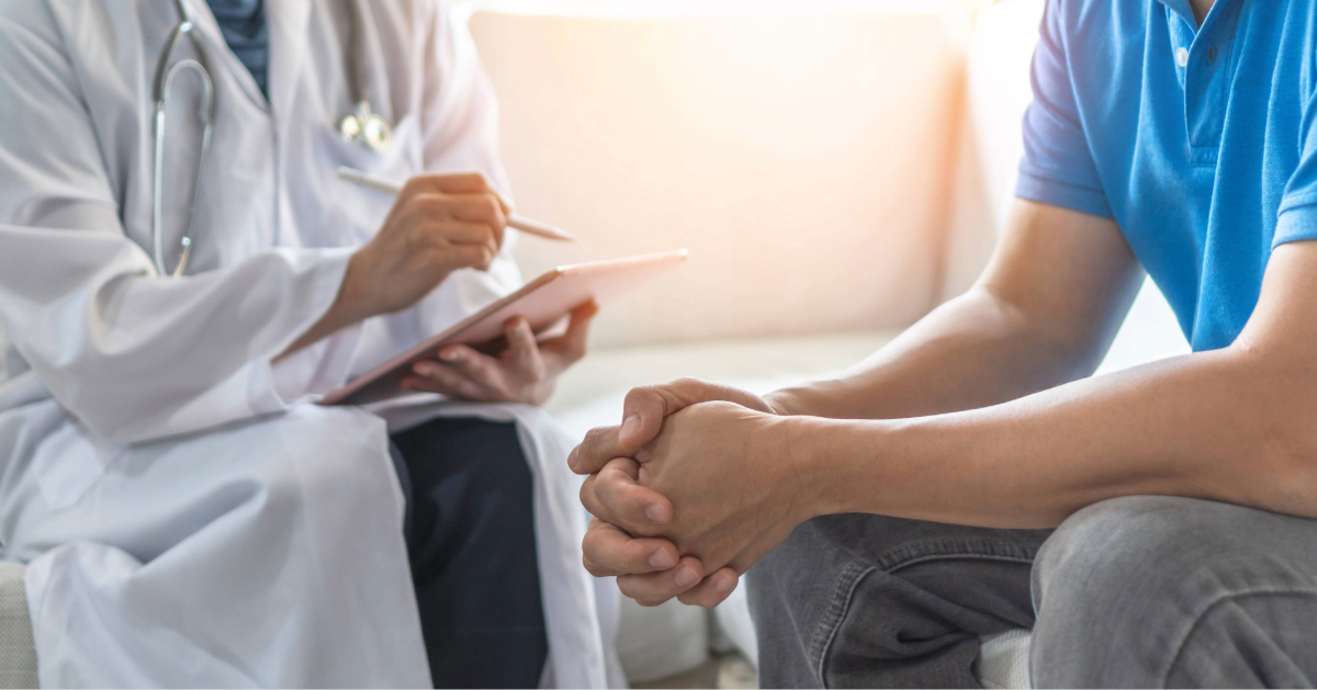 Healthcare provider discussing treatment with a patient during a clinical visit