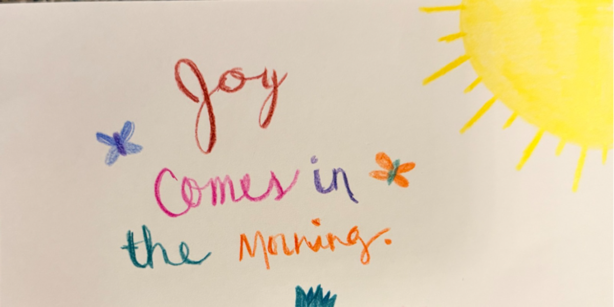 Hand-drawn illustration with the words “Joy comes in the morning” written in colorful lettering.